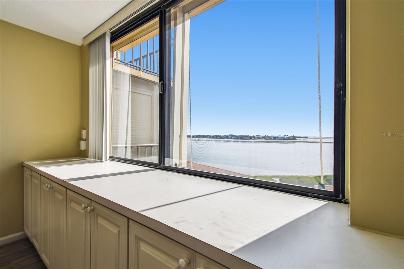 Primary bedroom built ins and beautiful view of the bay