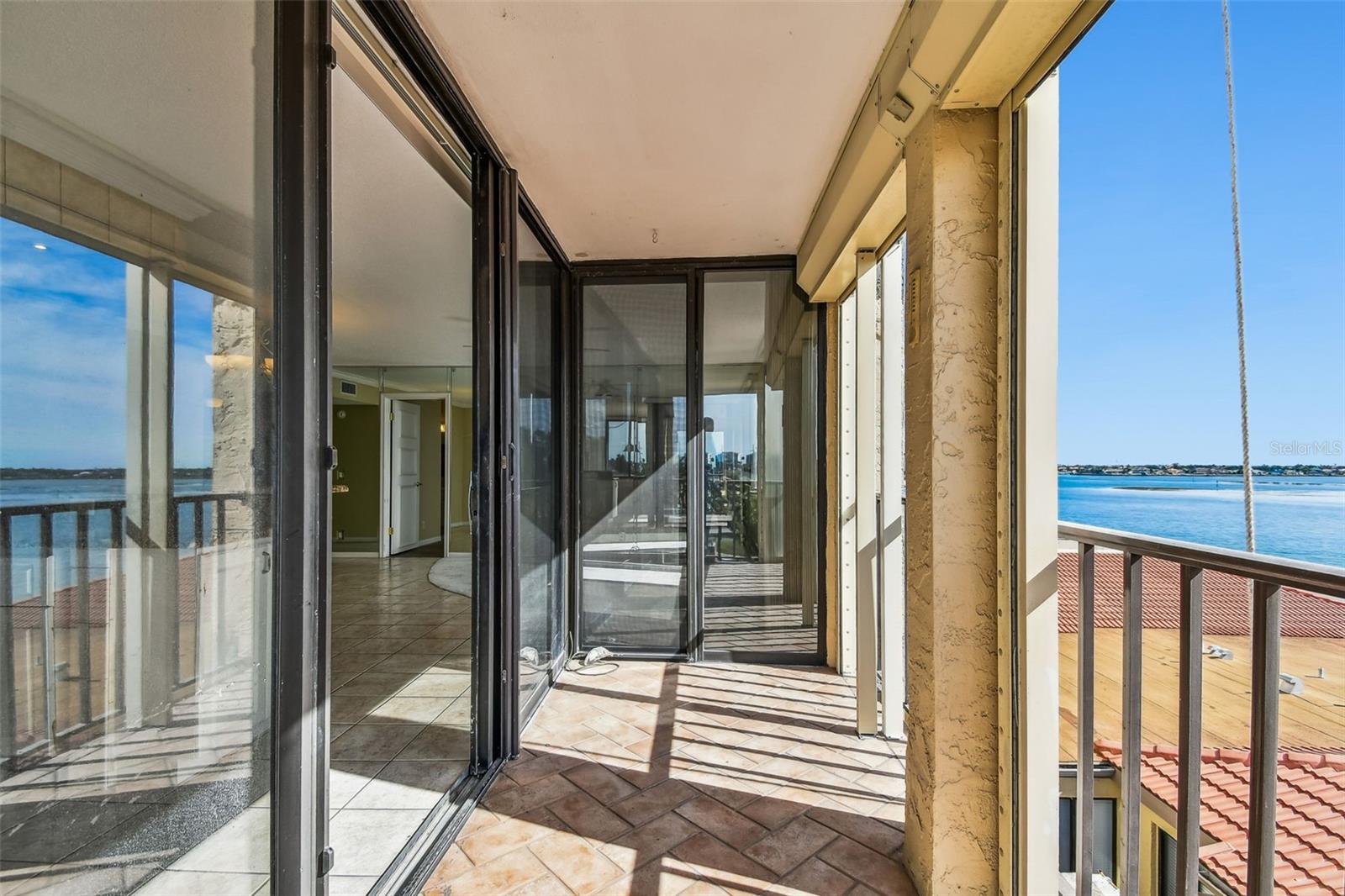 Balcony with waterfront view and hurricane shutters