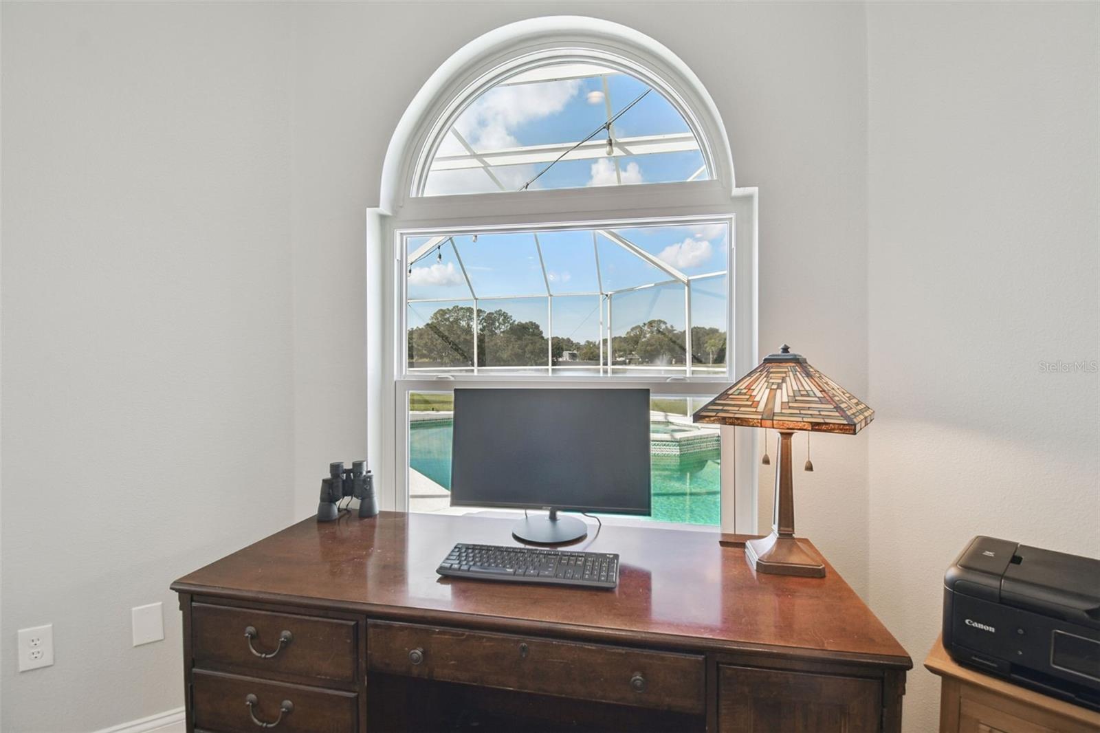 Workspace in bedroom overlooking pool and pond