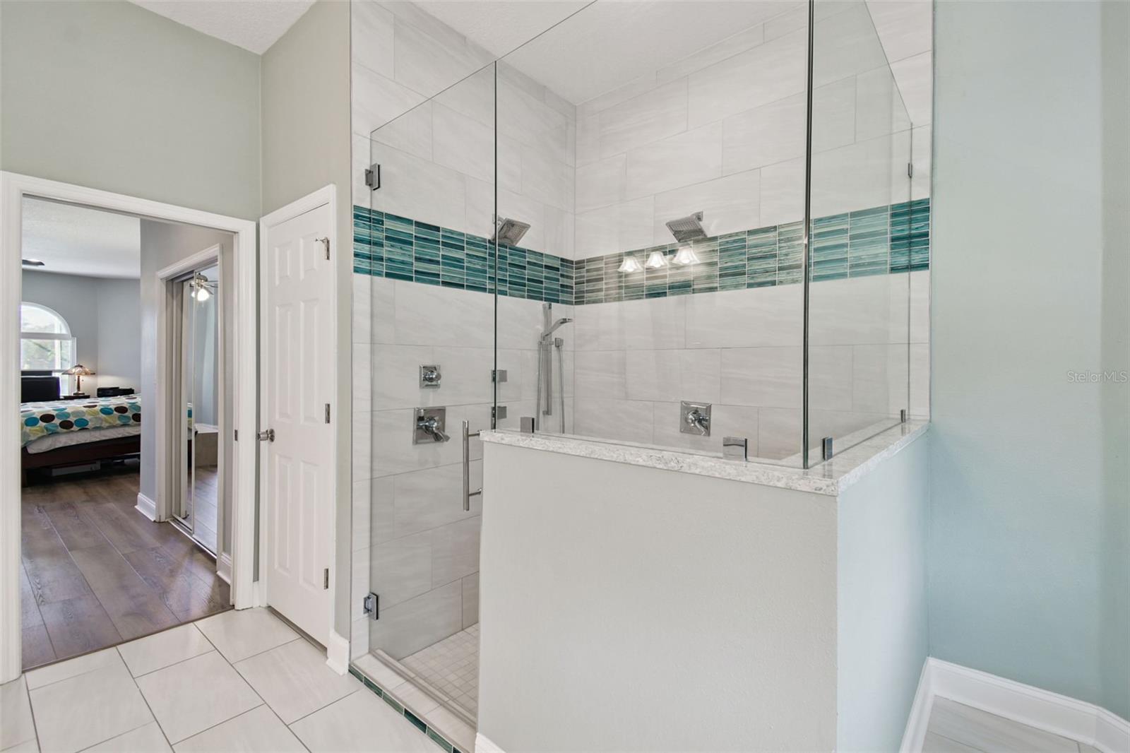 large walk-in shower with dual shower heads, body jets and a handheld