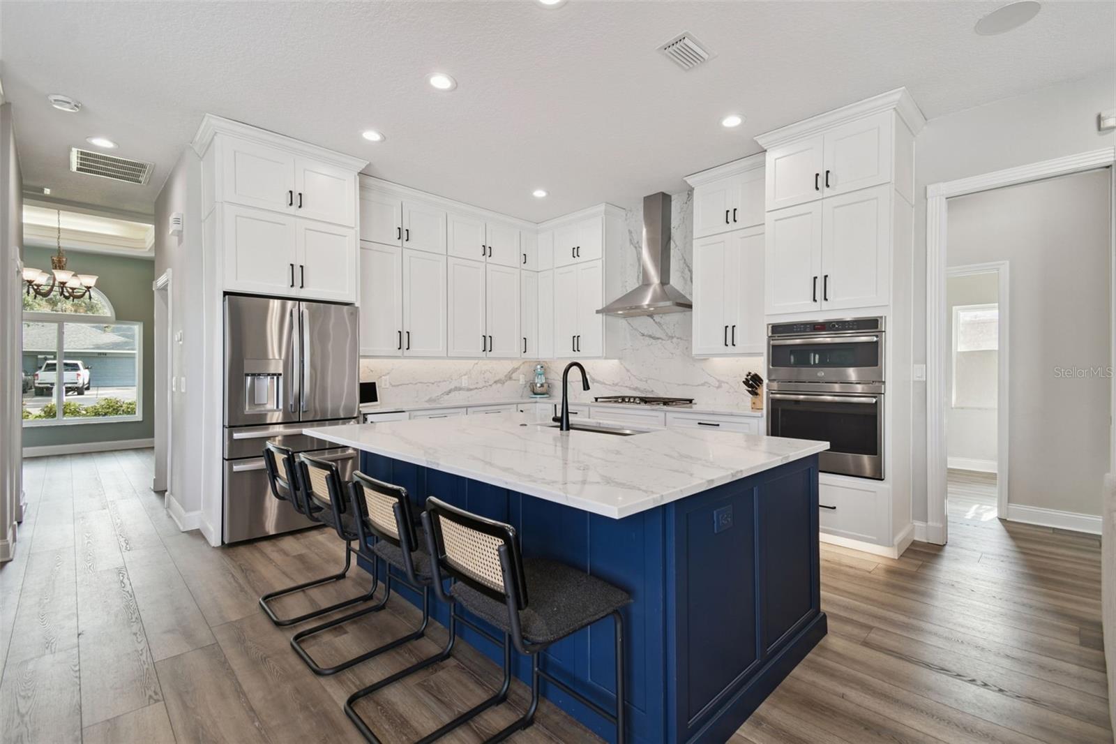 Stunning Kitchen with large island, custom cabinets, quartz countertops, and stainless steel appliances