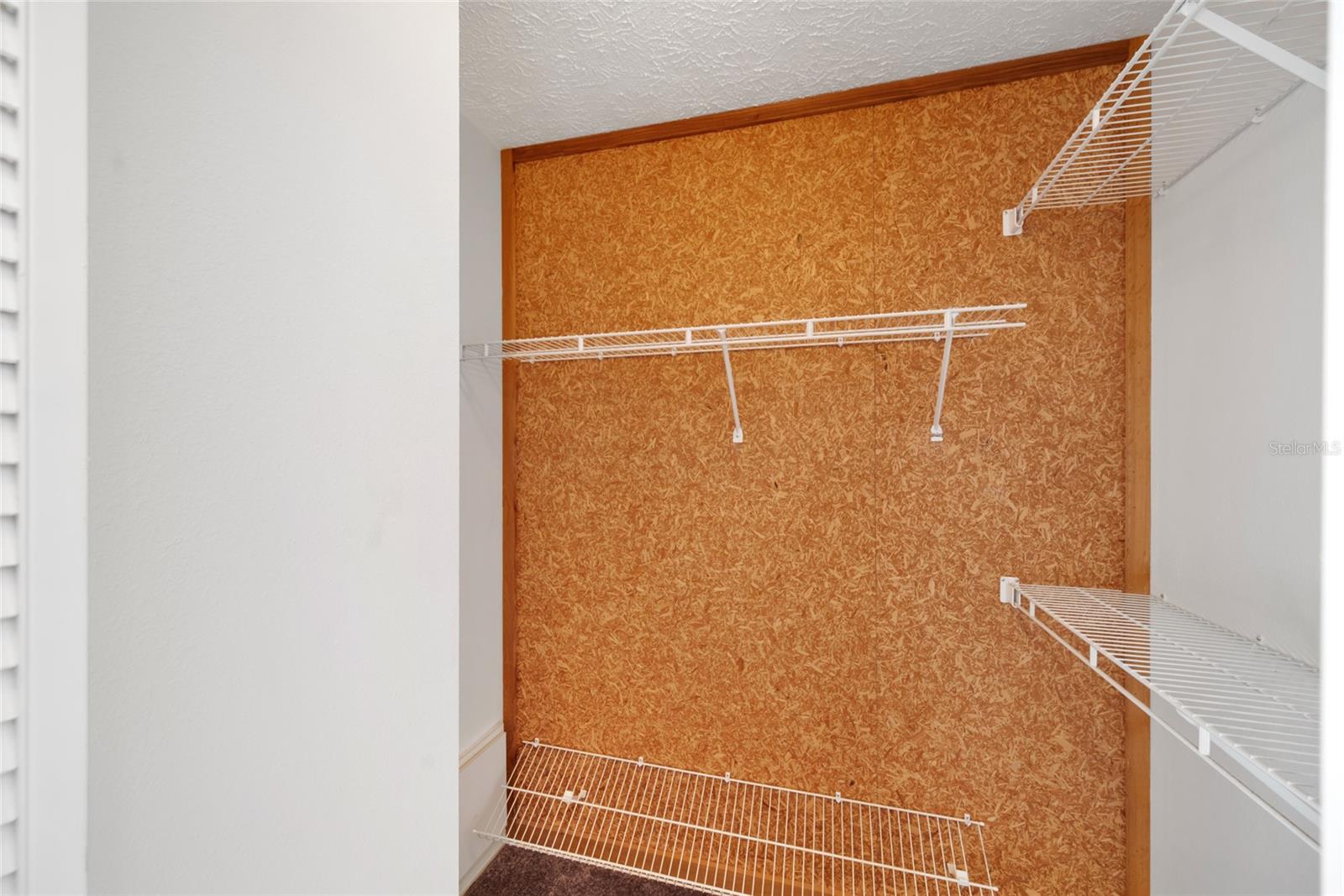 Double walk-in Cedar lined primary bedroom closet.