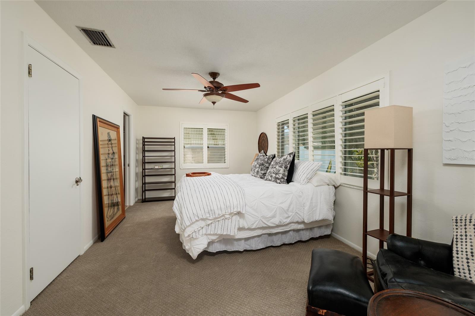 Plantation shutters and large primary bedroom