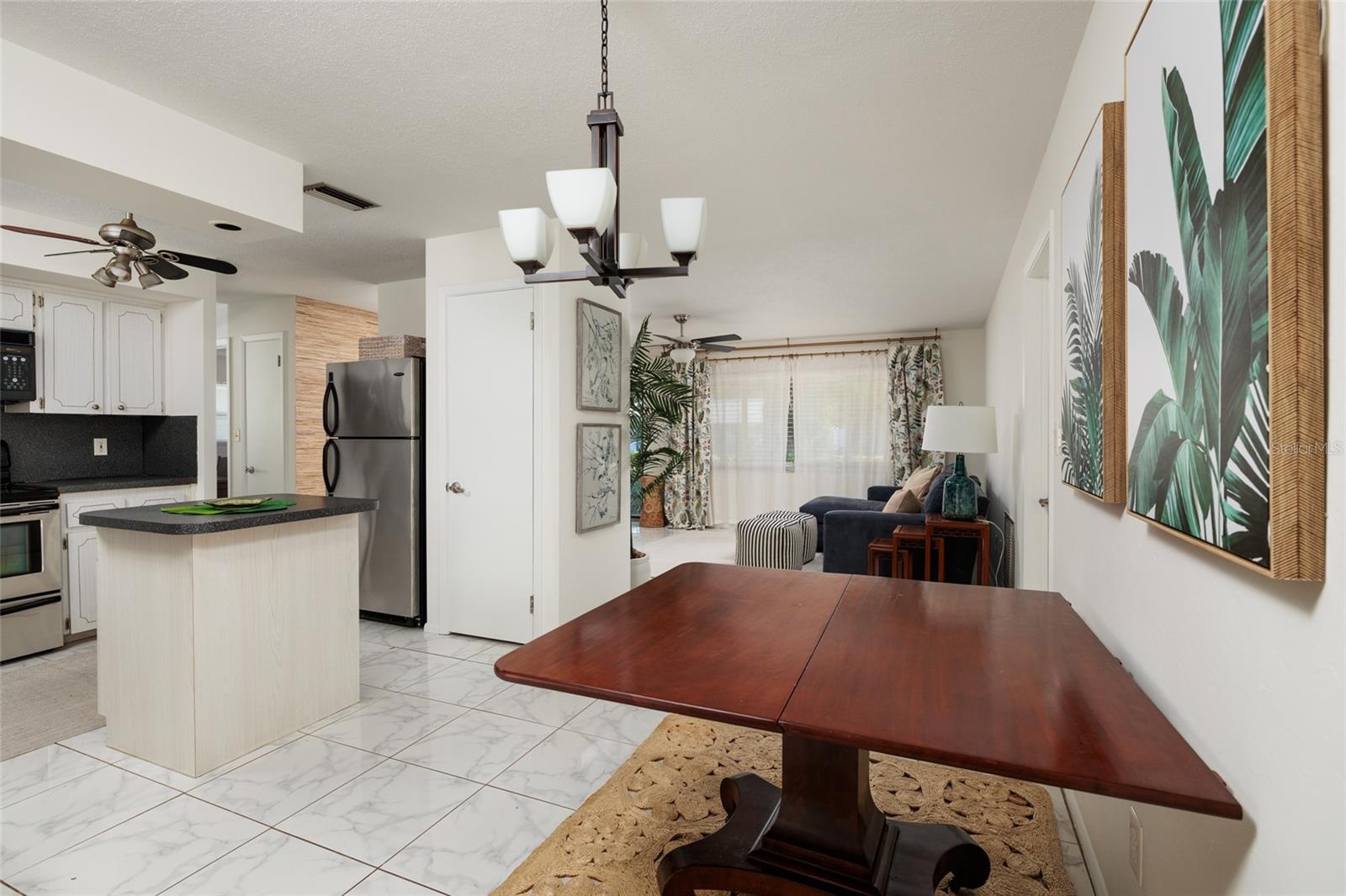 Dining area with kitchen on left and living room in the distance