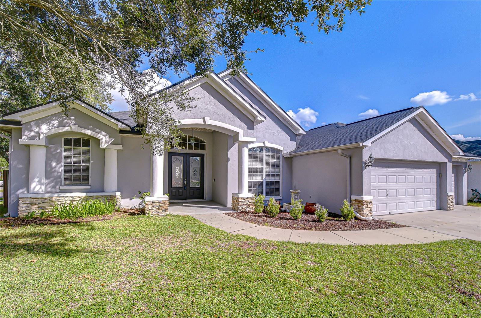 Welcome home! Beautiful curb appeal and lush landscaping greet you here.