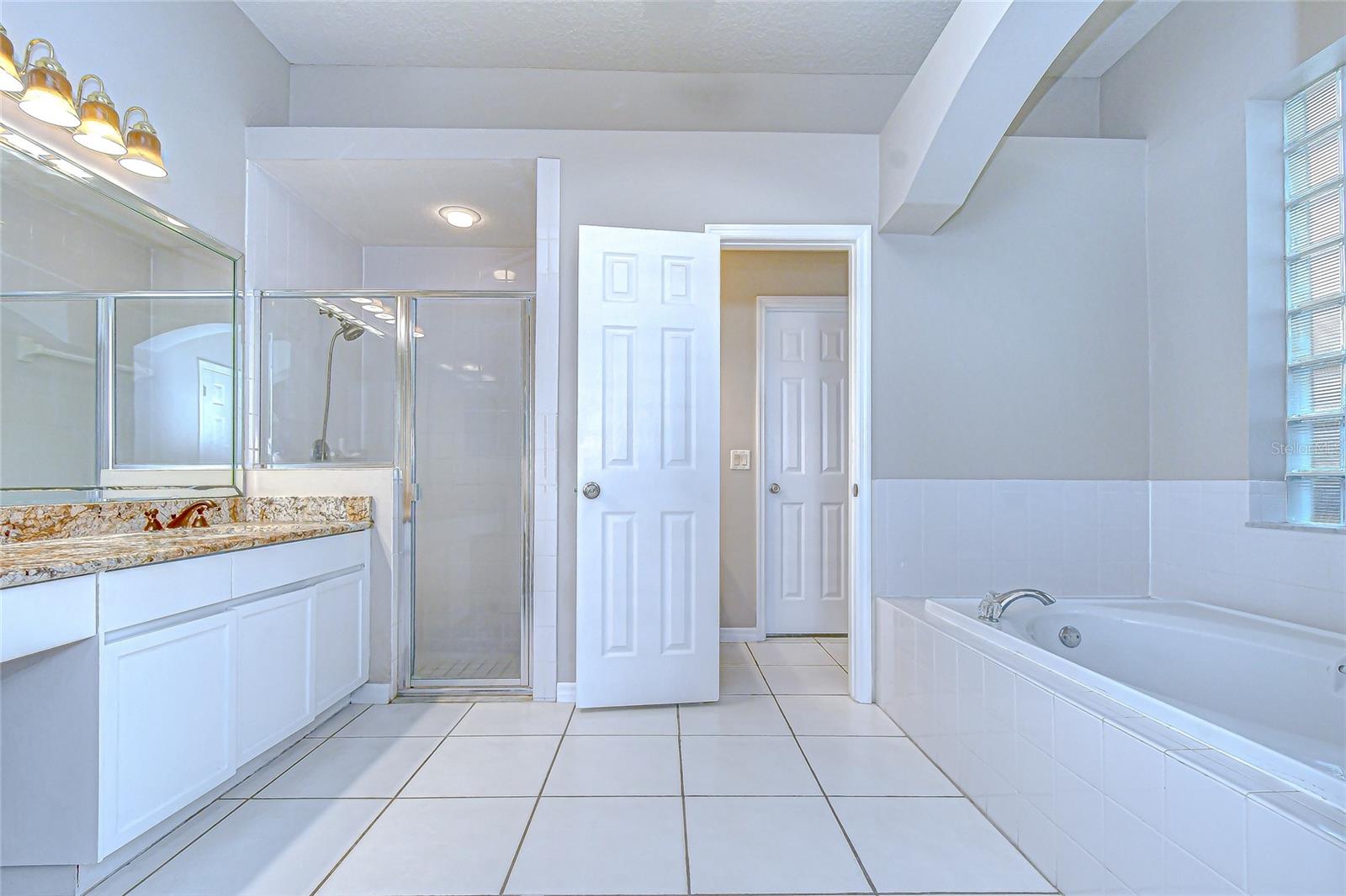 Spa-like ensuite bathroom with garden tub and walk-in shower.