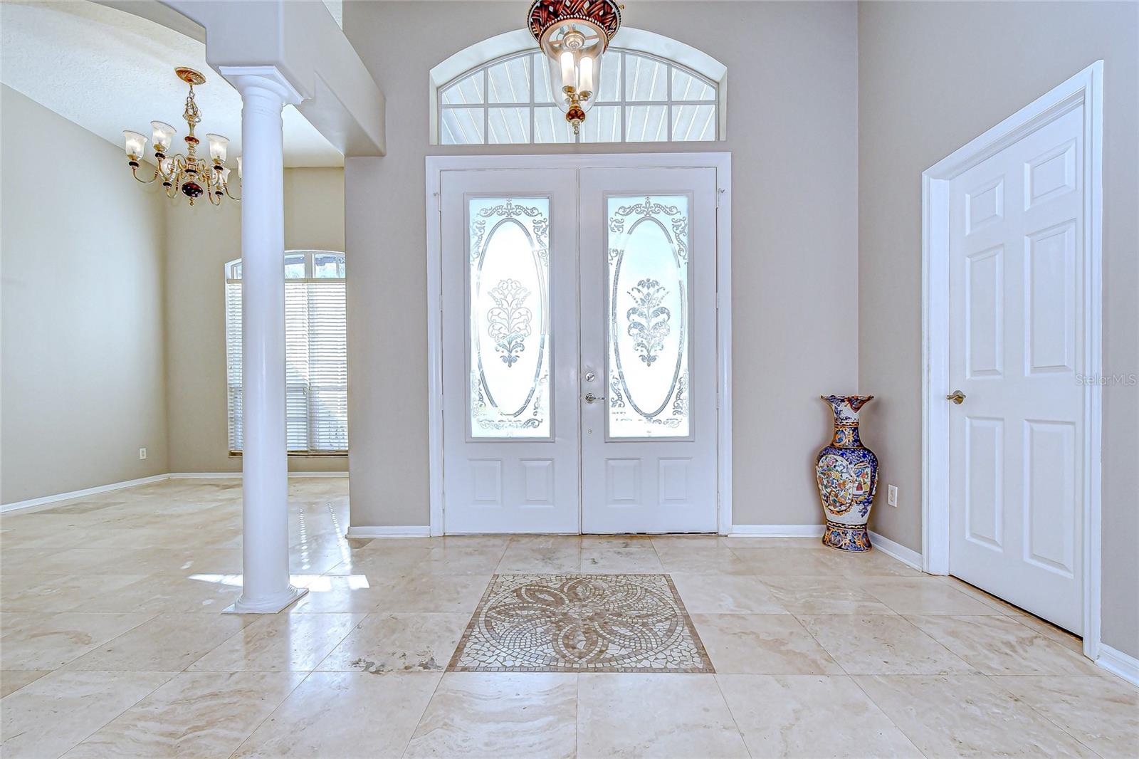 Step into a grand foyer with soaring ceilings—welcome home!