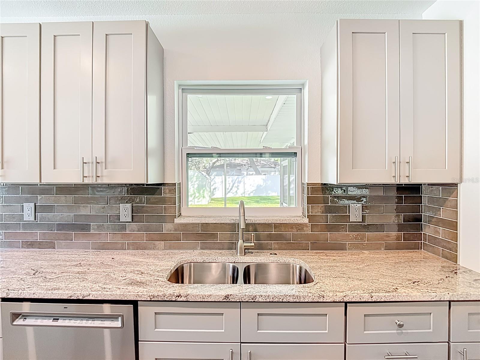 Newly Remodeled Kitchen with View to Backyard