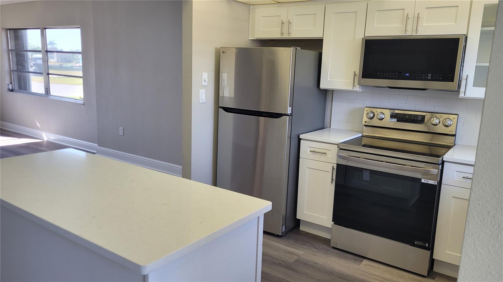 Newly remodeled kitchen with stainless steel appliances and quartz countertops