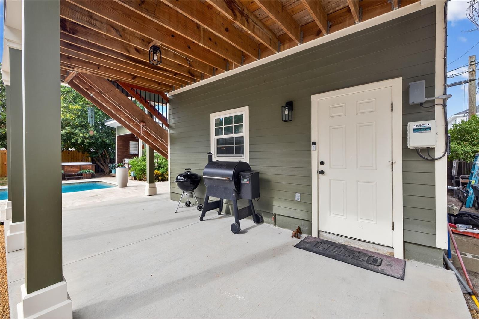 Bottom Covered Porch of ADU... door leads to a full climate controlled bathroom