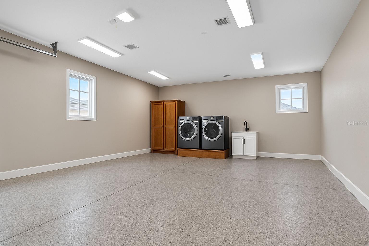 Climate Controlled 2 Car Garage with (2) Laundry Hookups; only one shown here.