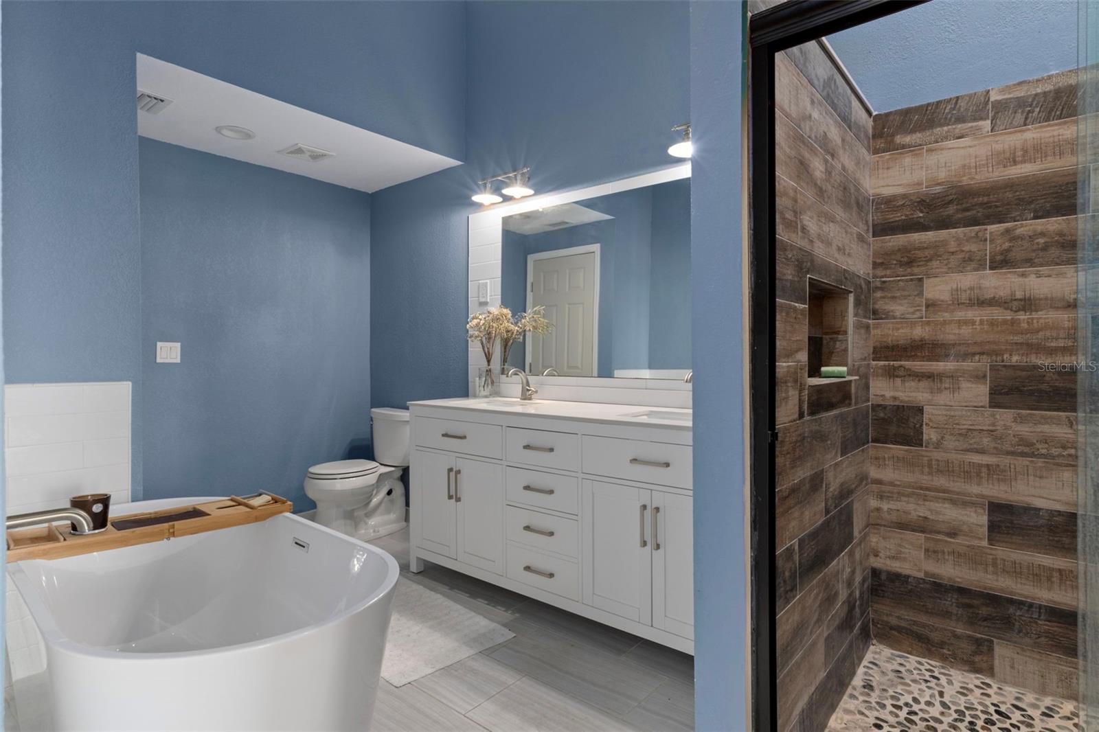 Master bath with large walk in shower and soaking tub