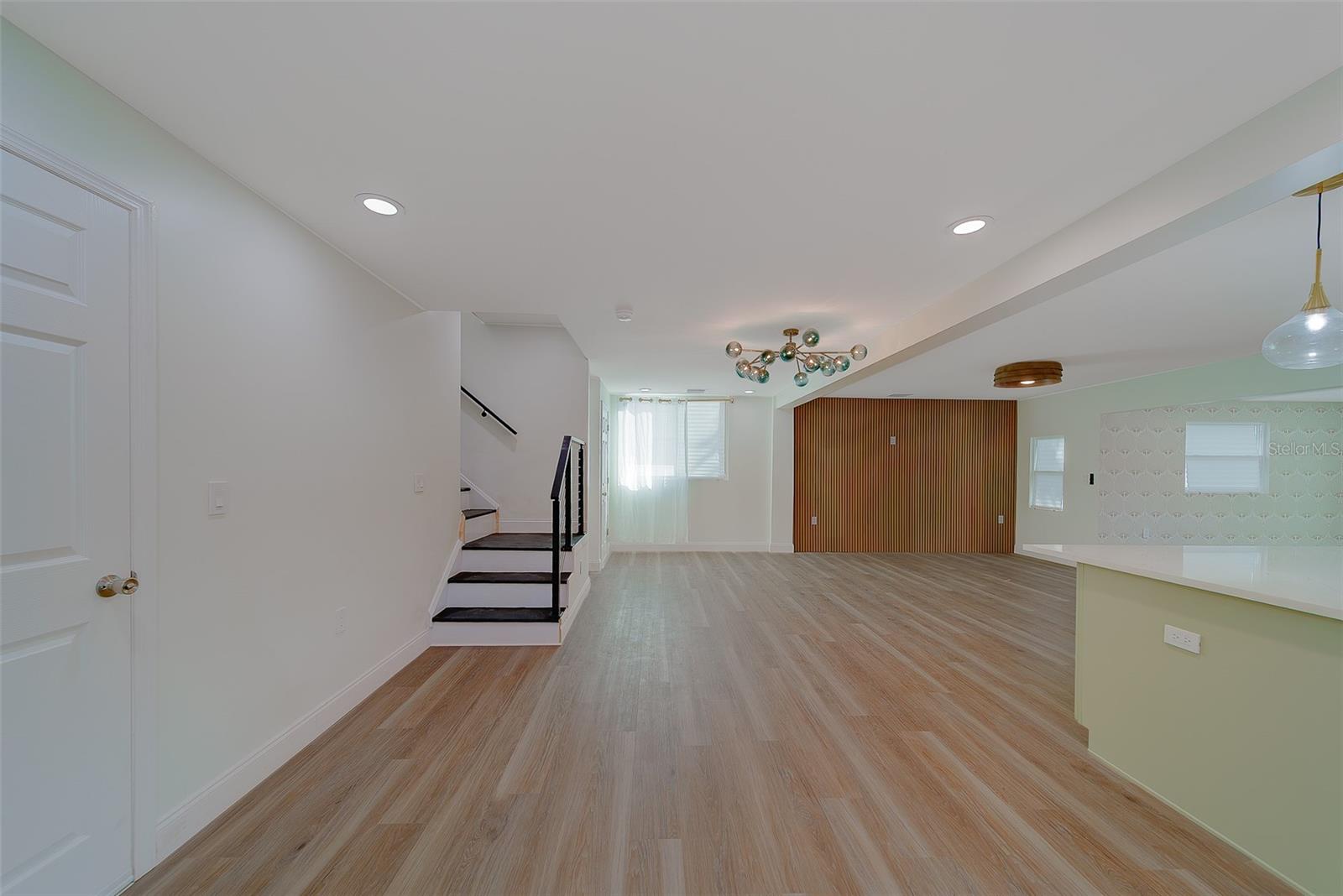 Looking into great room just outside of door to the garage