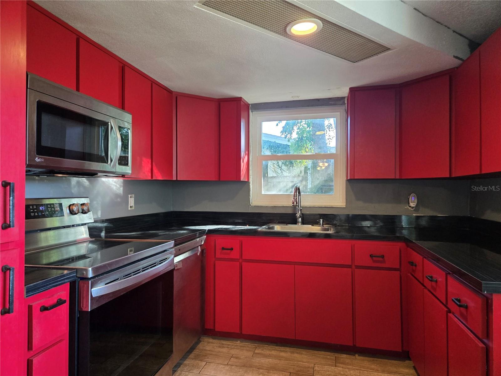 The kitchen shines with modern stainless appliances installed just a few years ago
