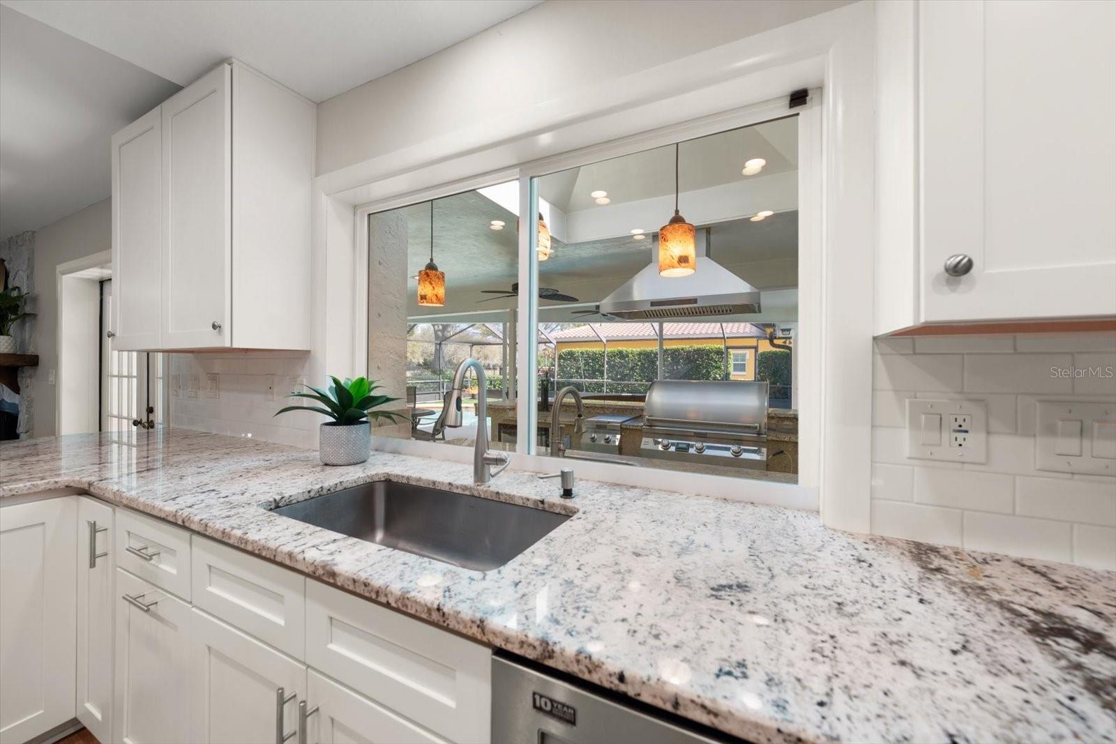 Pass through window to assist with grilling at the outdoor kitchen!