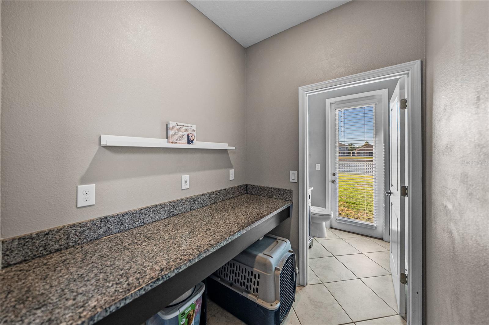 Mud room can serve as staging area for lunch boxes, book bags, pet kennel or even a desk