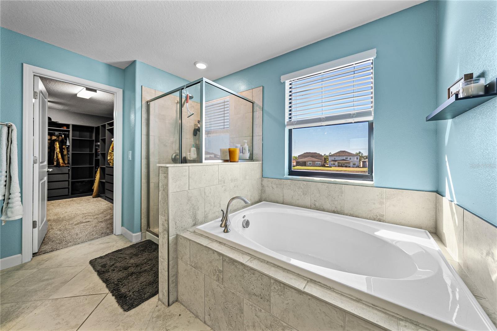 Primary bath features separate tub and shower