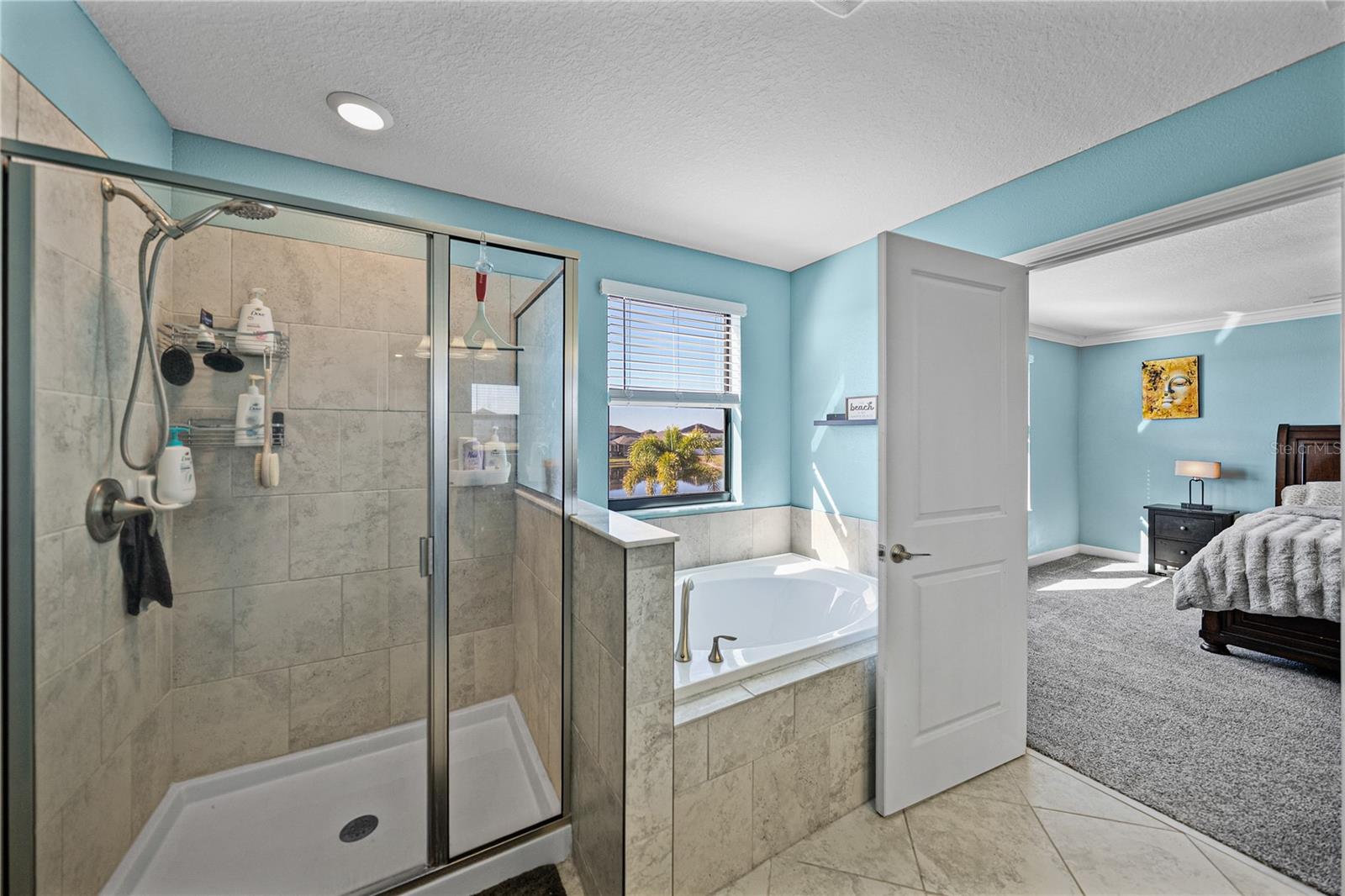 Primary bath features separated tub and shower