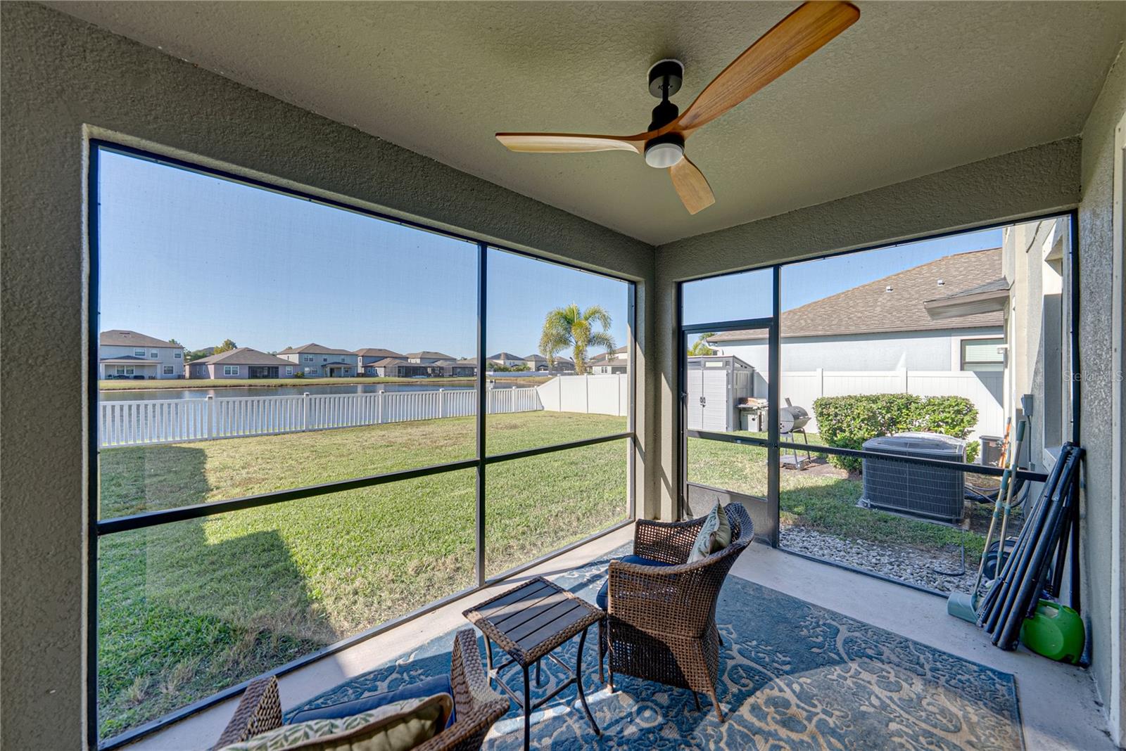 Screened lanai features a ceiling fan