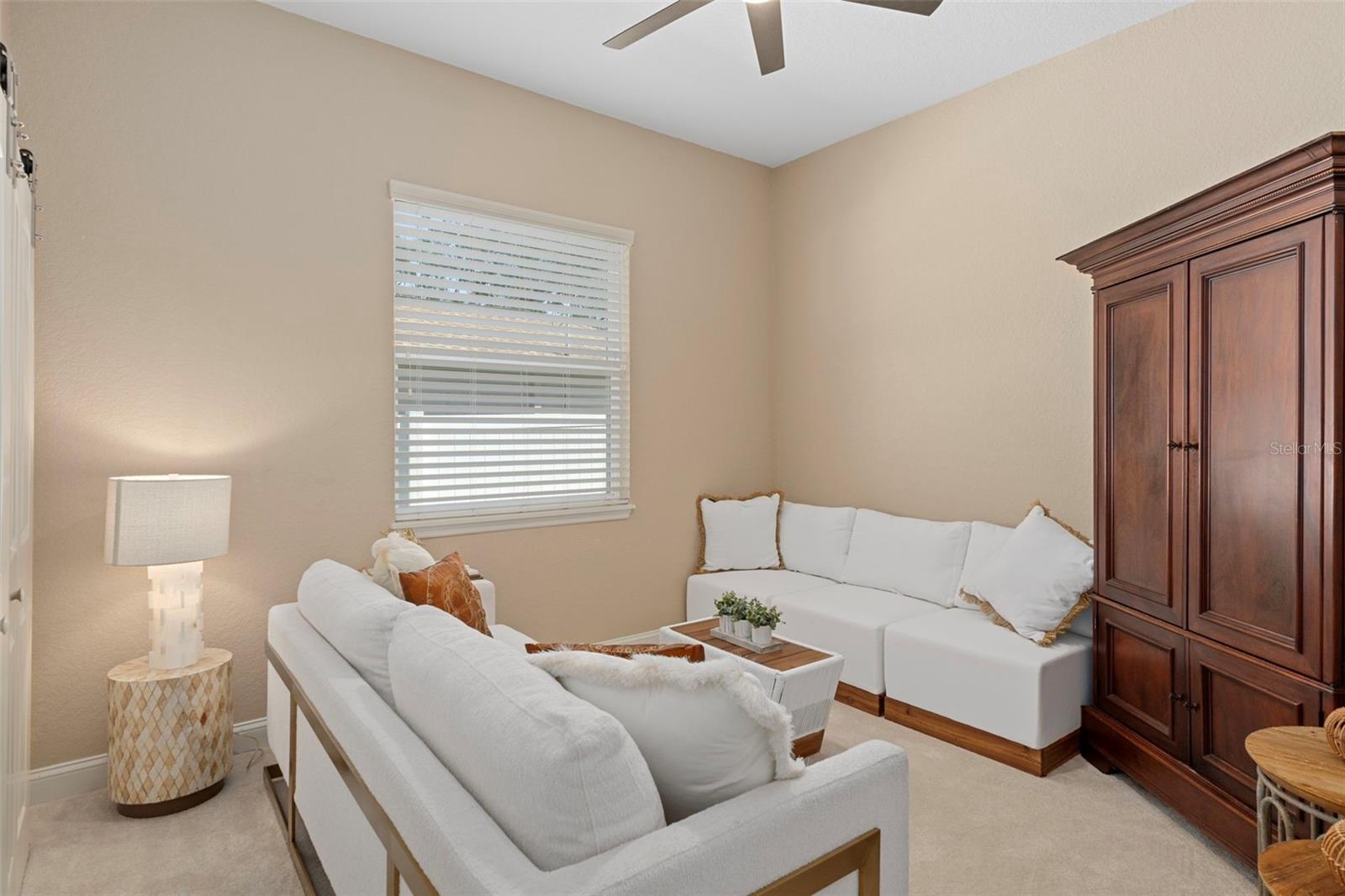 Cozy second bedroom with soft natural light.