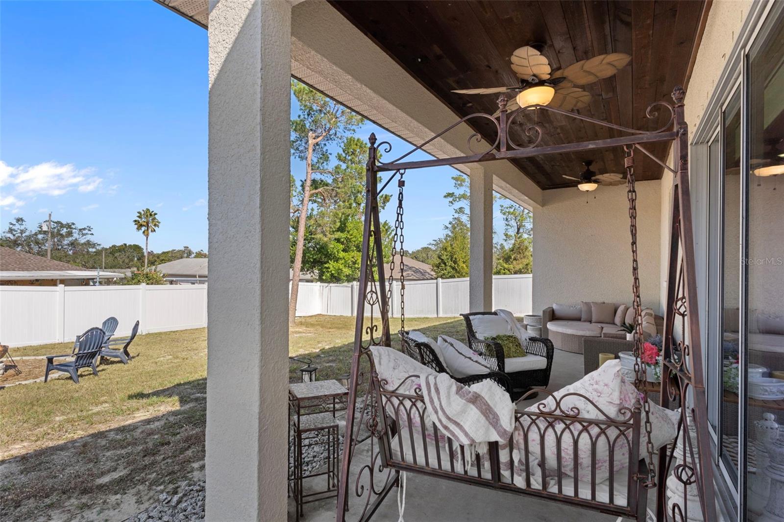 Wood-paneled ceiling adds charm to this covered patio