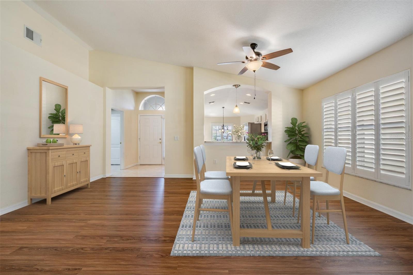 View of kitchen and entry foyer - virtually staged