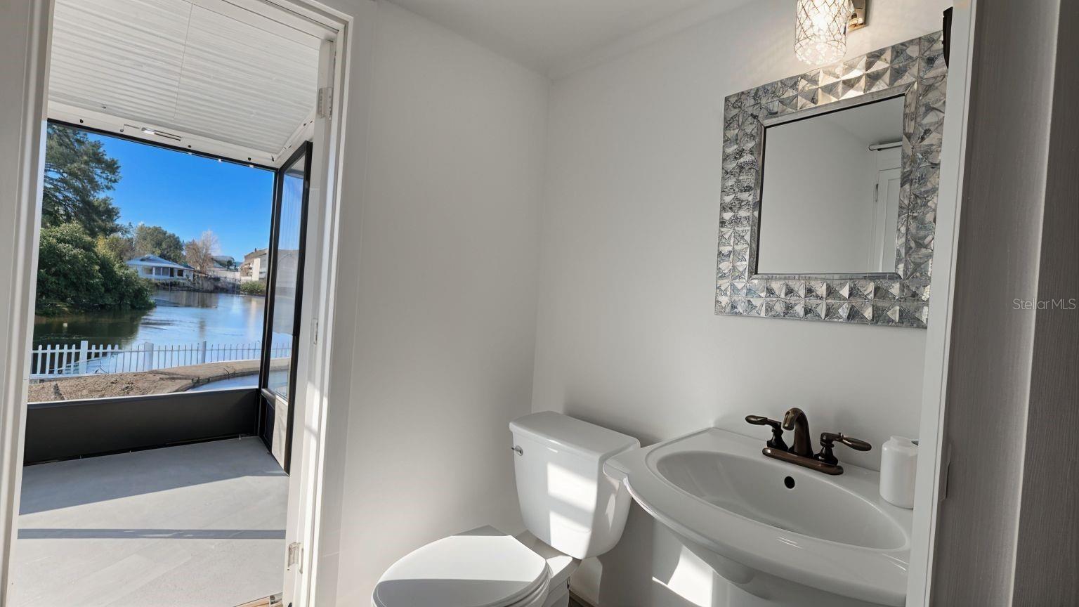 Half Bath leads to Lanai/ Pool. cell photo