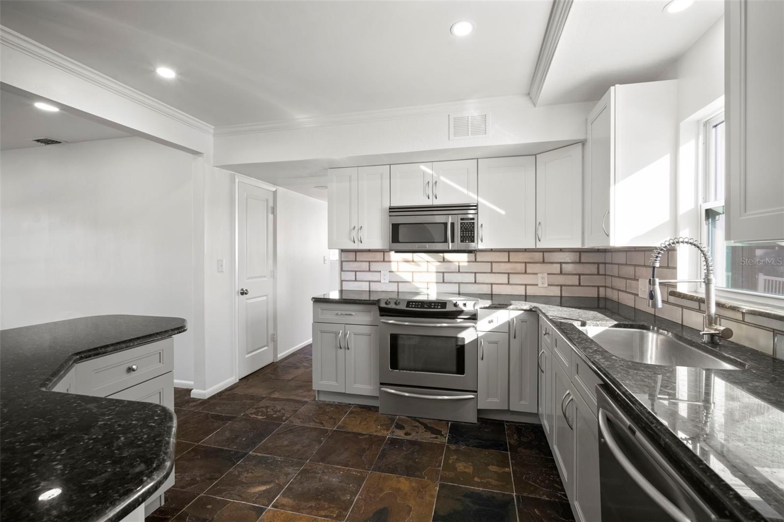 Massive kitchen with updated Shaker style cabinets.
