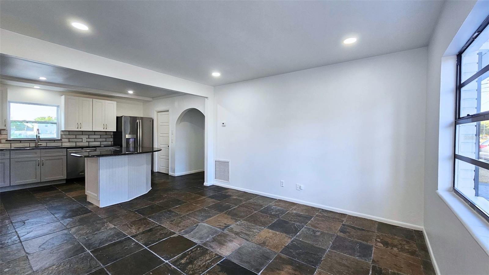 Spacious dining area. Door in background meets at stairs and front entry. Cell phone photot.