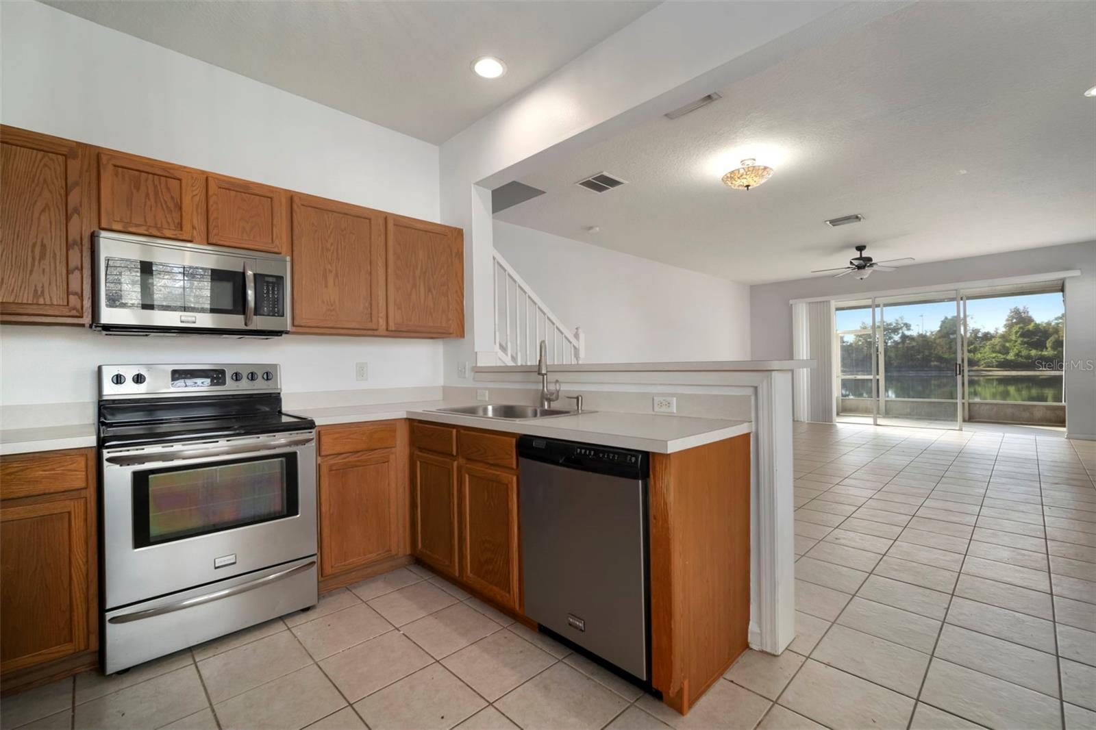 Zoom in and see the Waterview from the Kitchen. Gorgeous in-person.  Well-maintained Oak cabinets with stainless steel appliances.