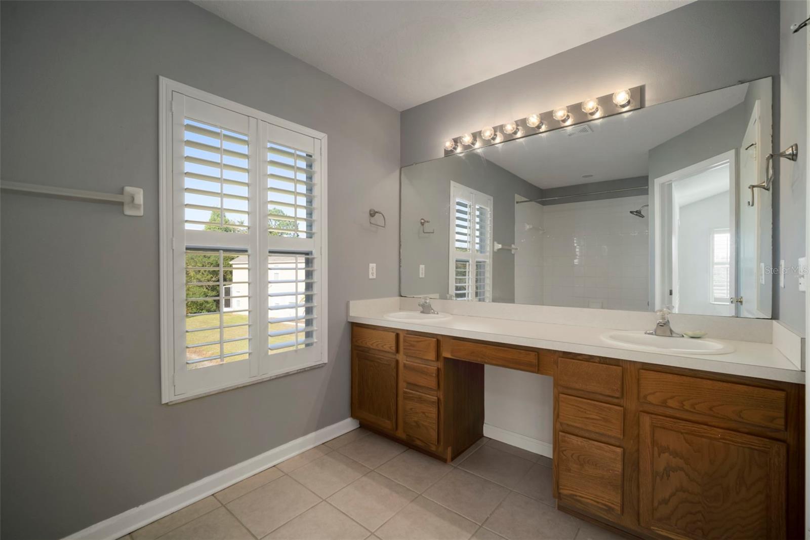 Window in Bathroom is "unique" to corner units. View entering Master Bath. Toilet to the right.