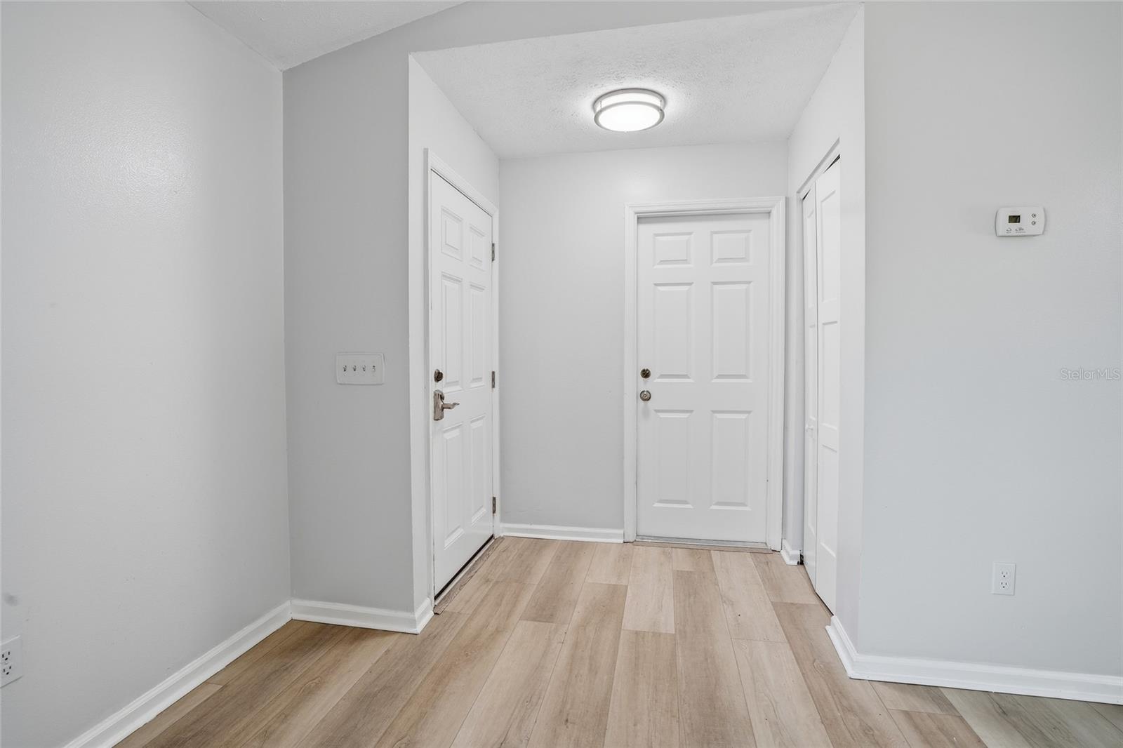 front entrance, garage interior door and coat closet