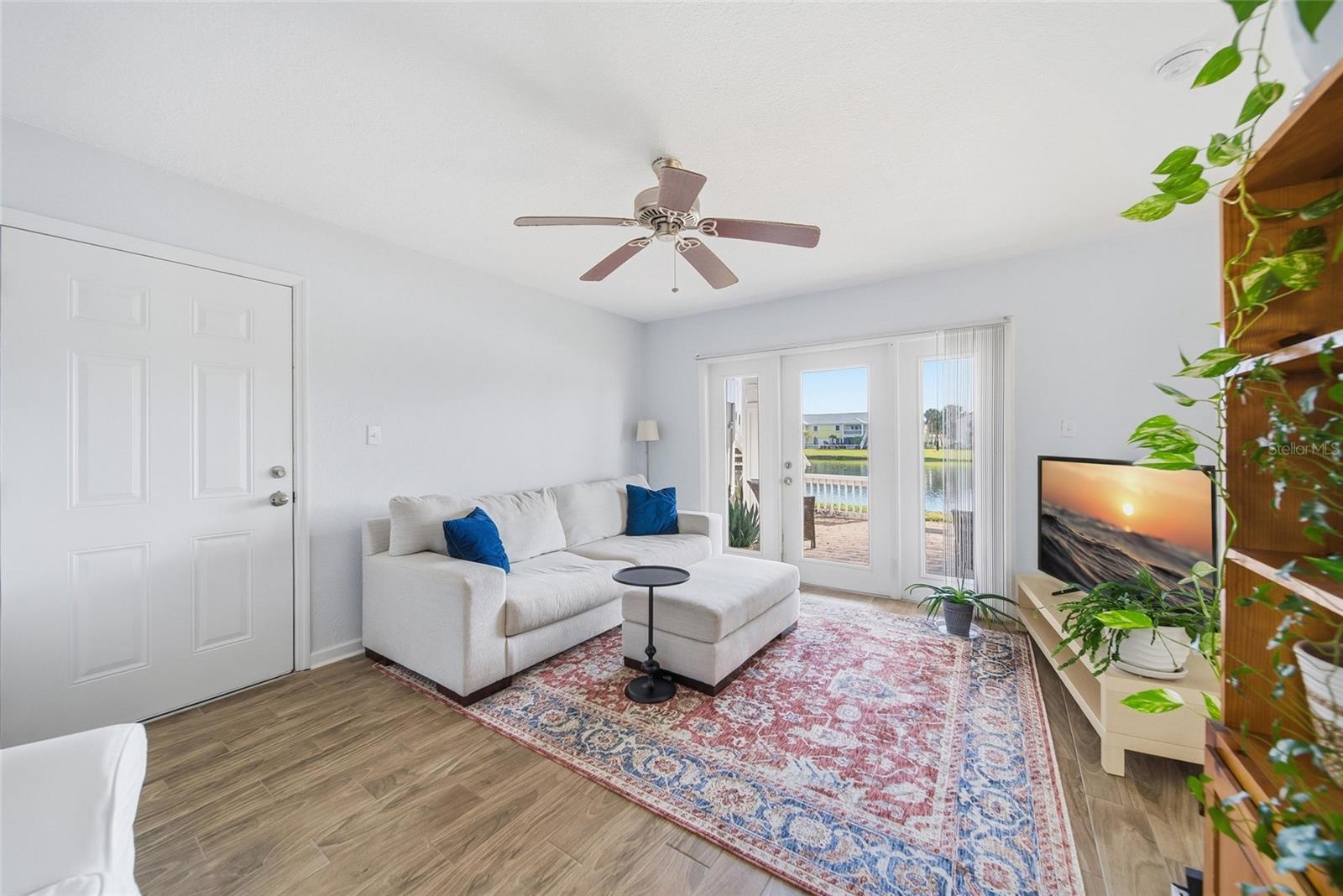 Alternate view of living room with view of the pond in the background.