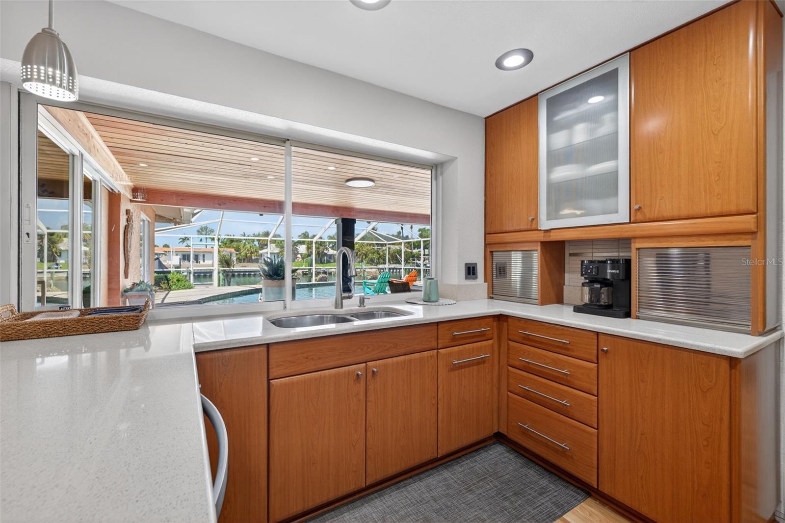 Picturesque views of the pool and saltwater canal from the kitchen