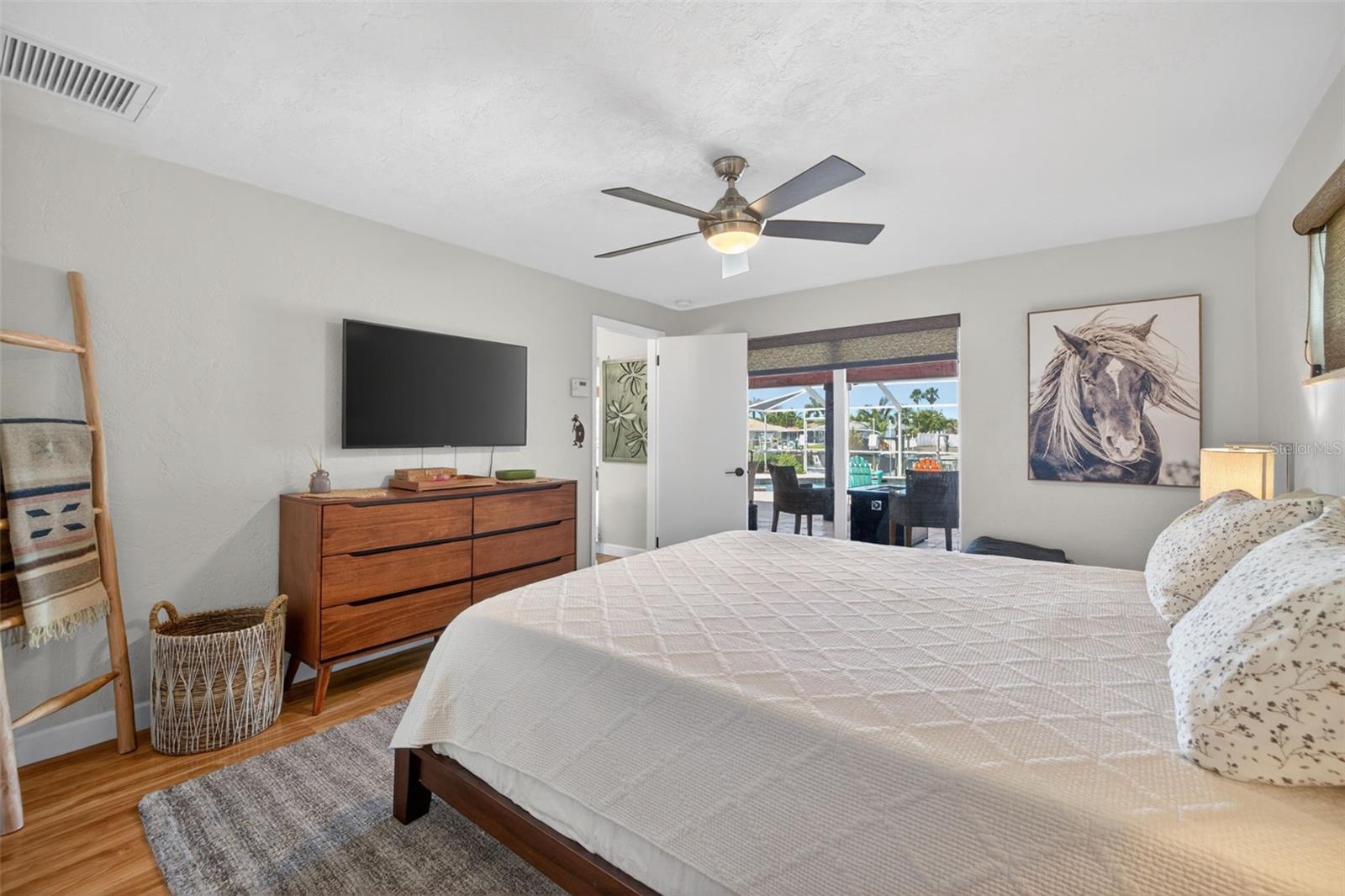 Primary bedroom with pocket slider to the back patio