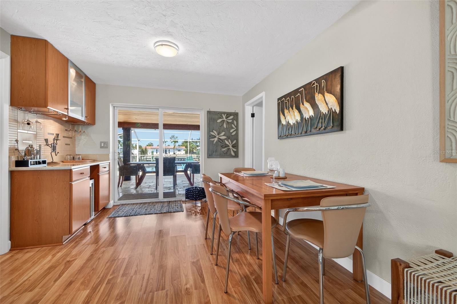 Dining room with views of the pool and dry bar