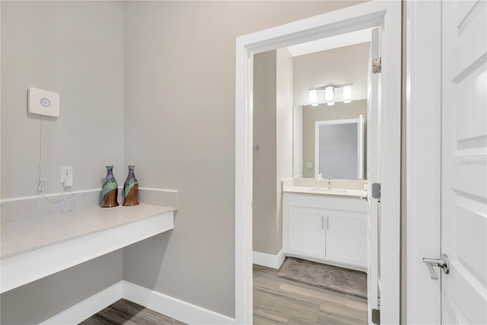 Storage area off the garage entrance and half bath.