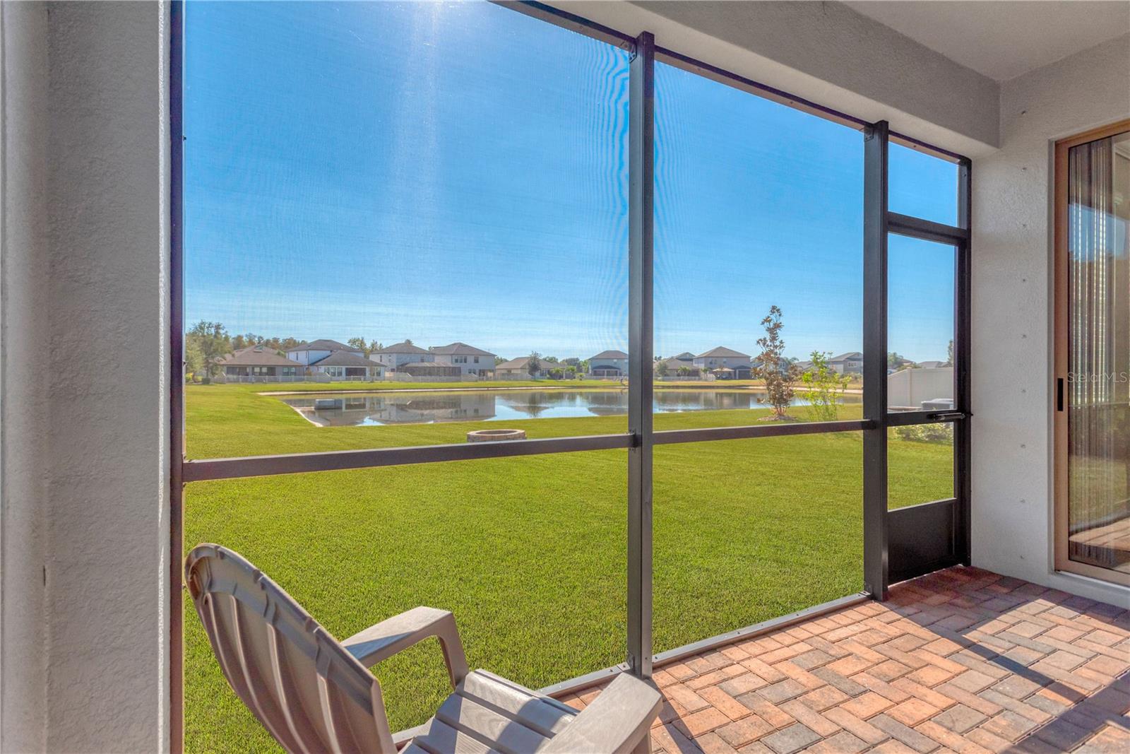 Screened lanai with pond view.