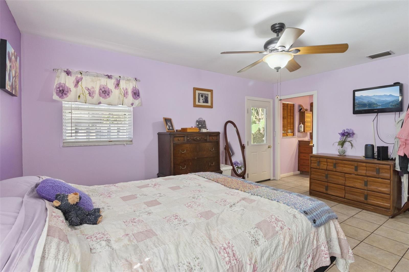 Primary bedroom with primary bath and door that goes to the pool