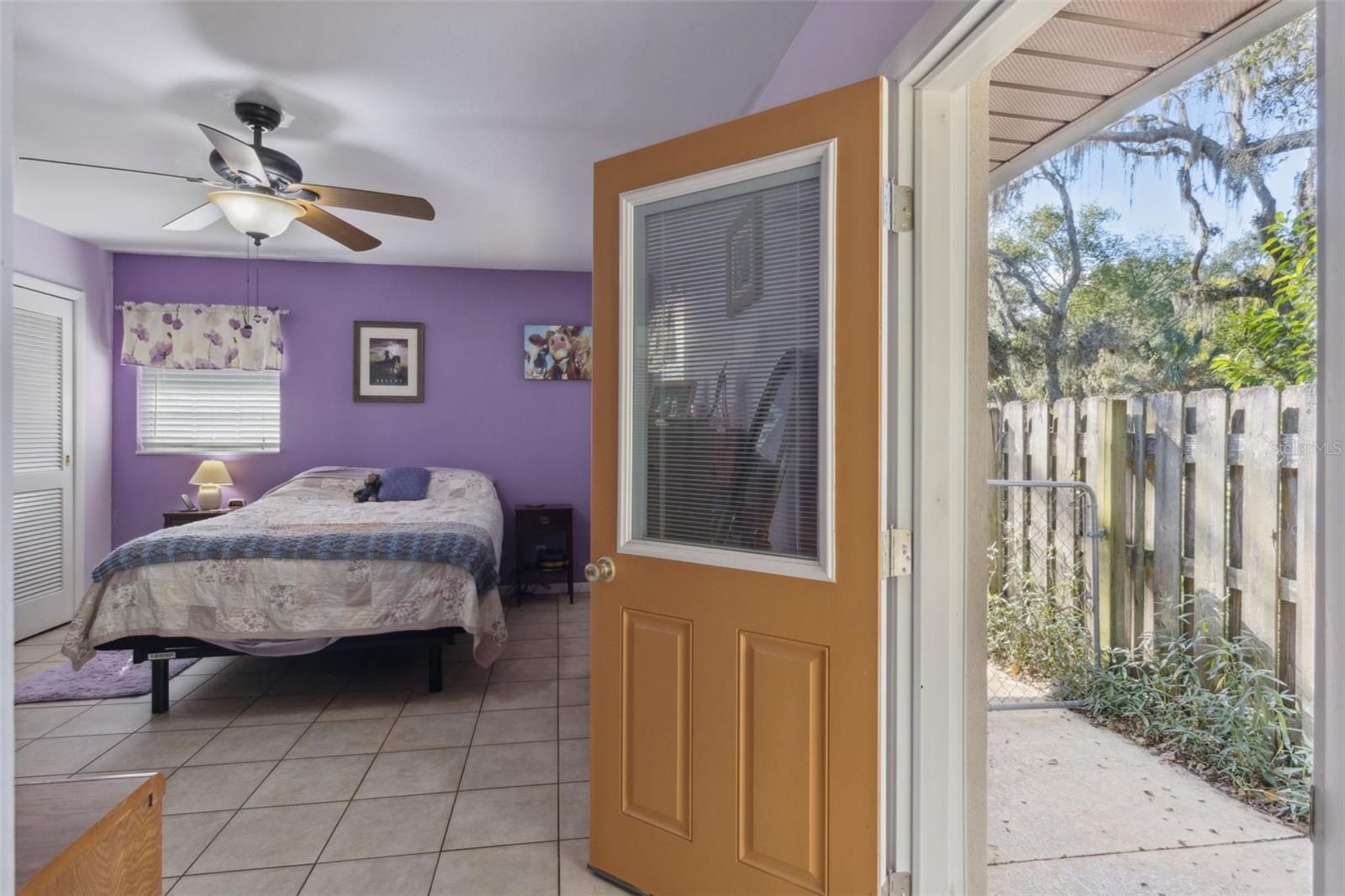 Primary Bedroom and door leading to back yard and pool
