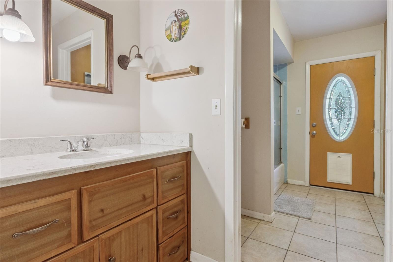 Guest Bathroom with door that leads to backyard and pool