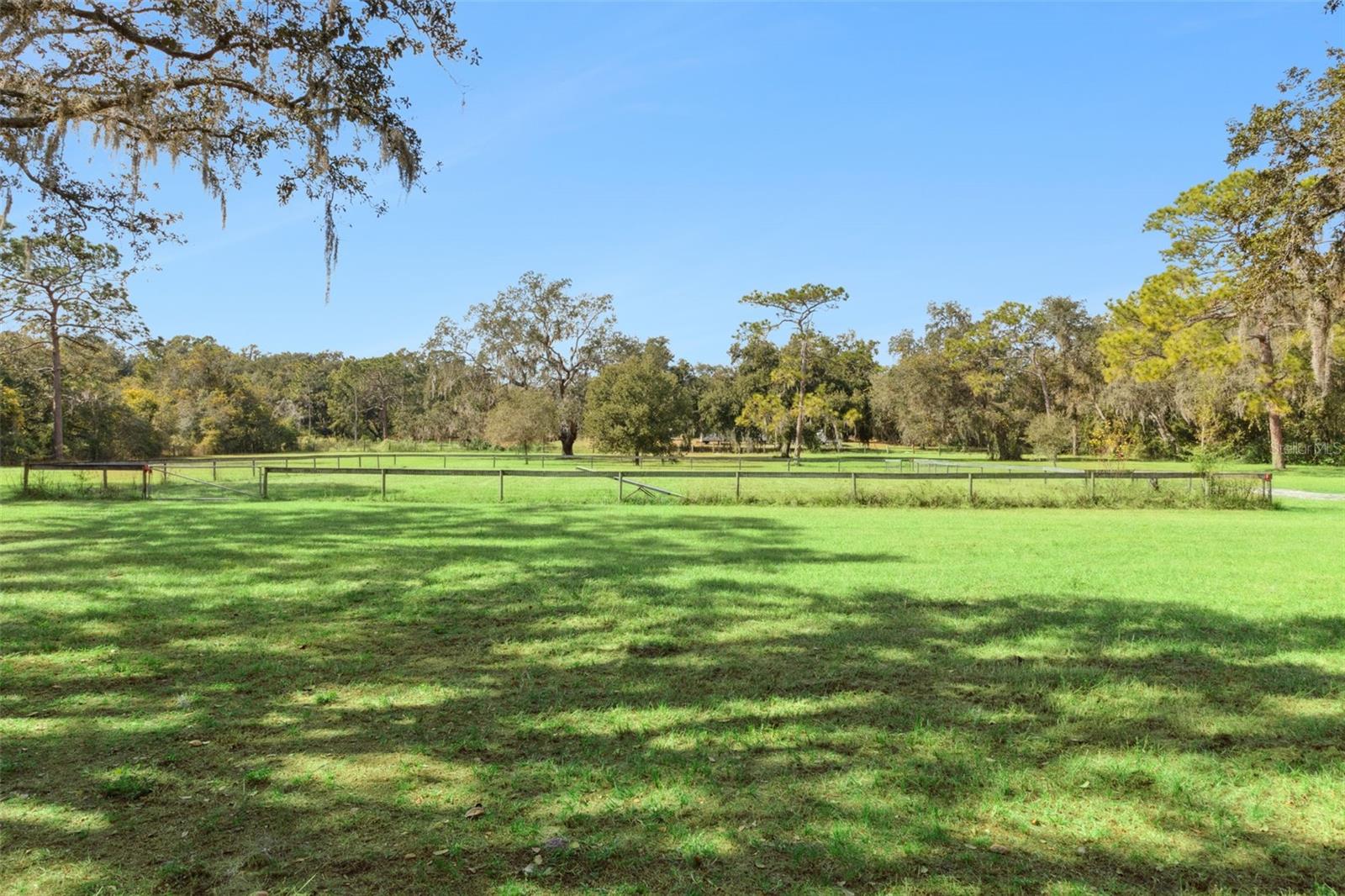 Back of property with fenced field paddock