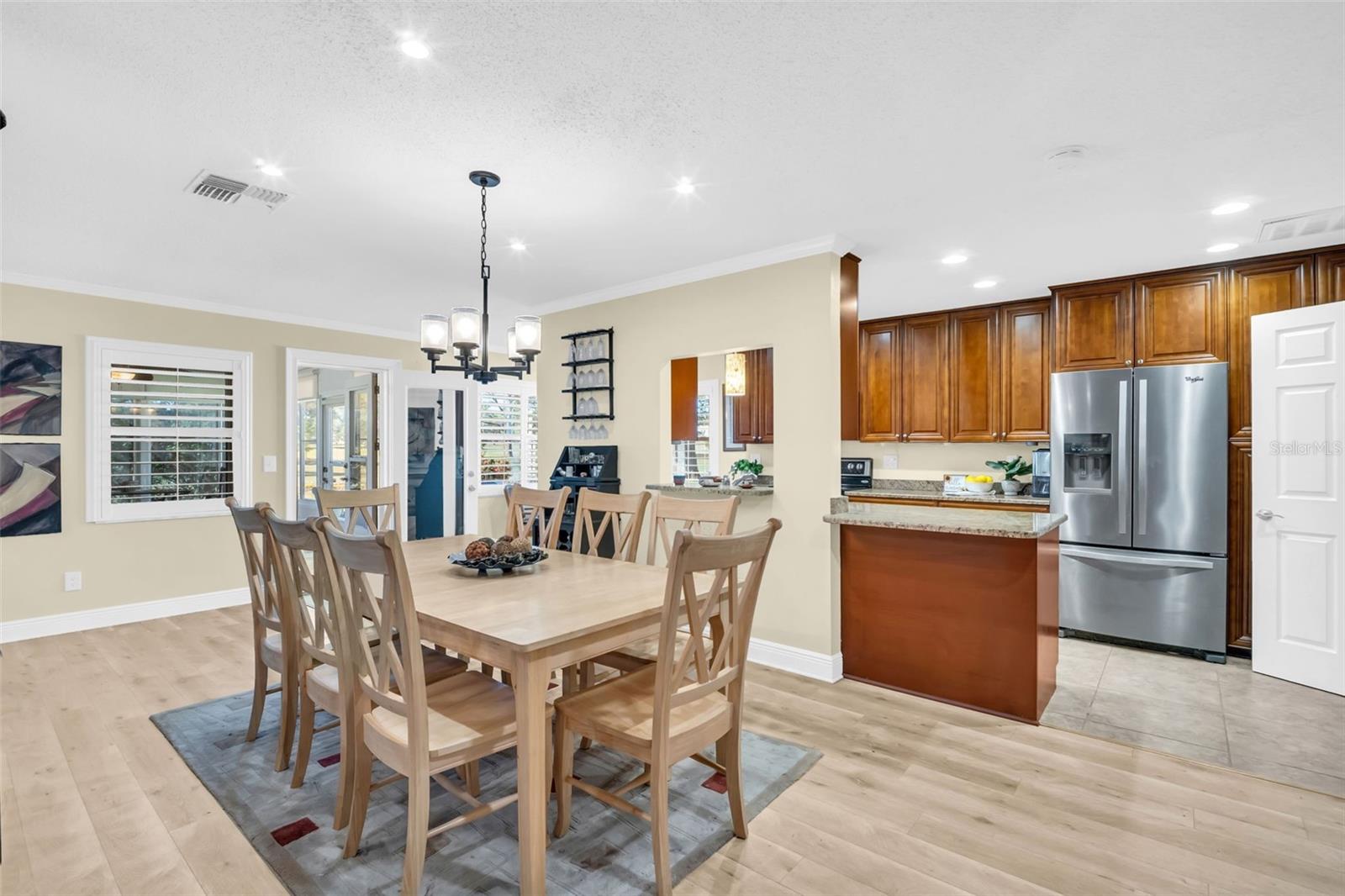 Spacious dining area for family and guests with handy pass-thru to the modern kitchen.