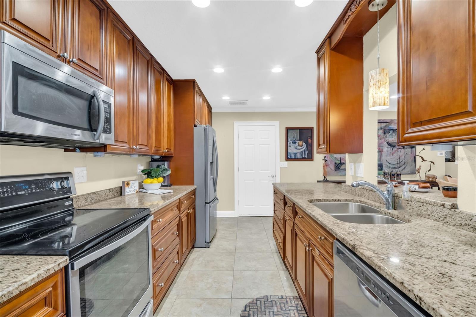 The kitchen has granite countertops and solid wood cabinetry.