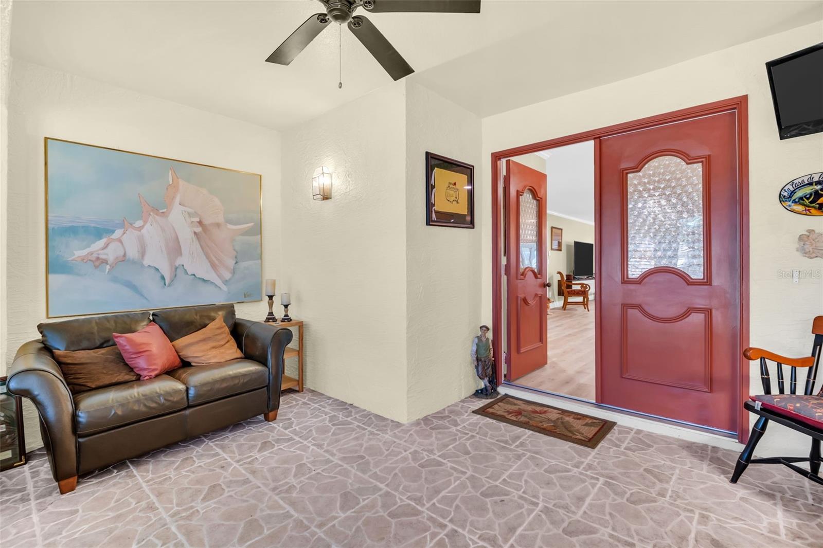 The entrance foyer is spacious and has beautiful double entry doors to the living area.