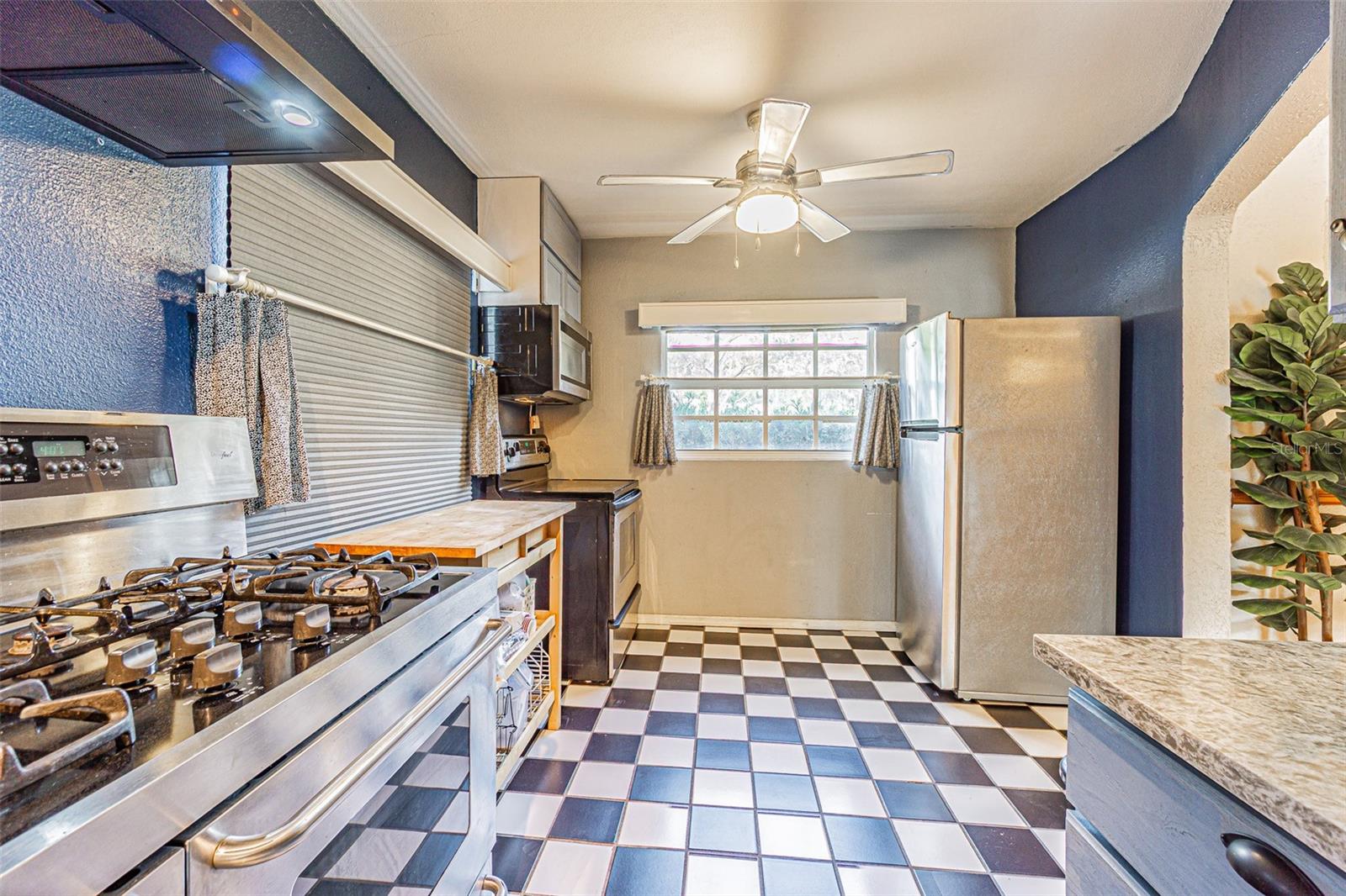 Kitchen with gas and electric stoves/ovens.