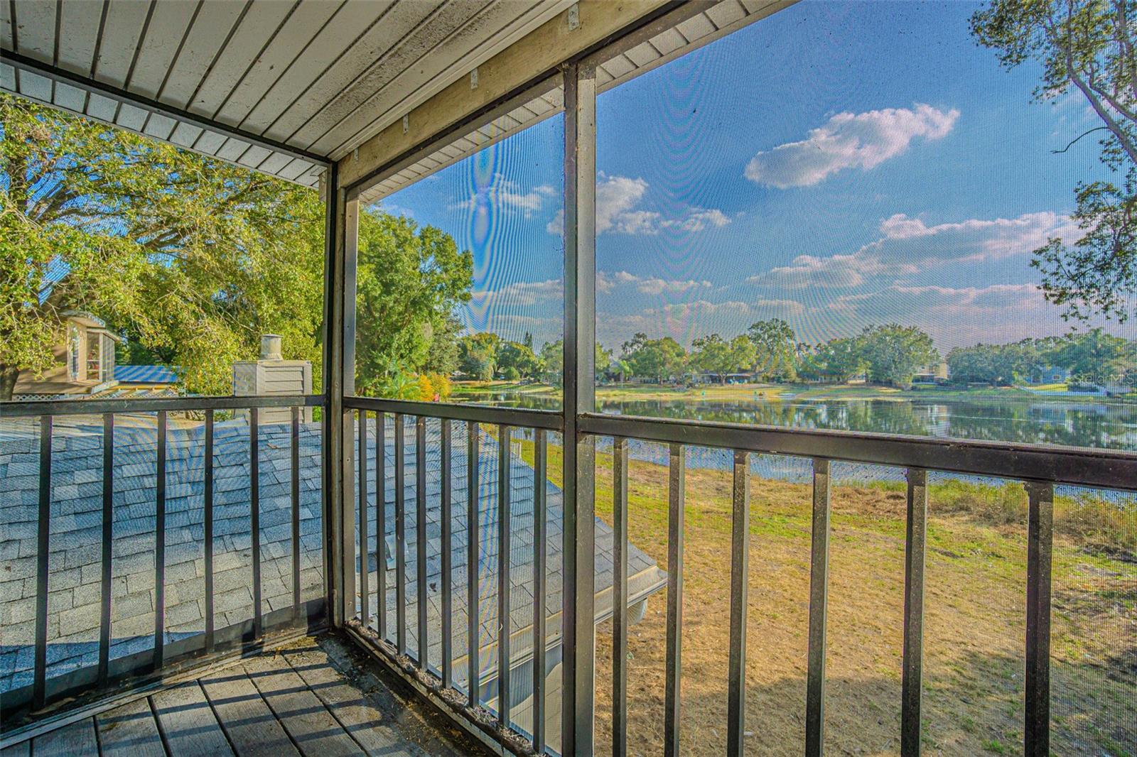 Screened balcony view from primary suite towards lake