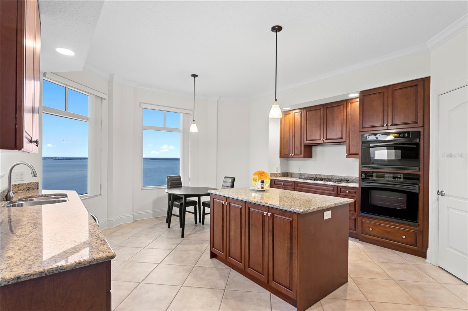 This spacious kitchen features a large prep island and captivating views that elevate everyday cooking.