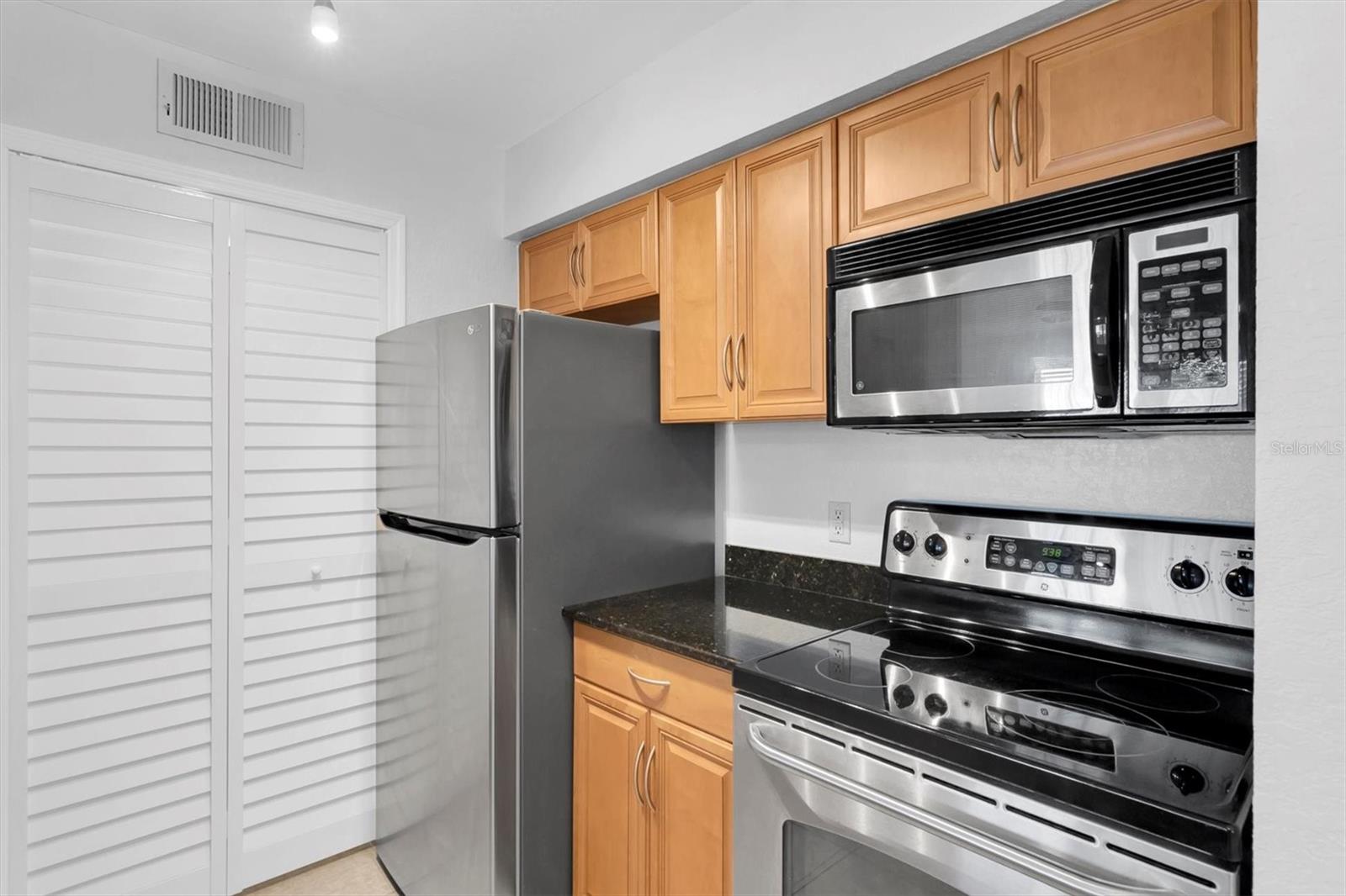 Wood cabinets with granite tops, stainless appliances. New Stove!