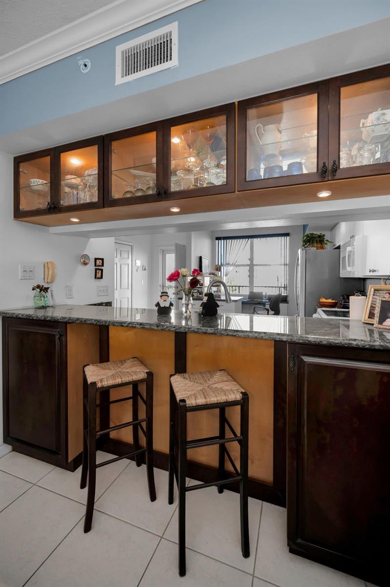 Custom built in cabinets above breakfast bar